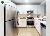 Thumbnail 11 of 39 - A modern kitchen with stainless steel appliances and white cabinets at Mission Hills, Camarillo, 93012