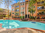 Thumbnail 13 of 18 - A large swimming pool in front of a multi-story apartment building at Casa Granada, Los Angeles, 90049