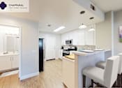 Thumbnail 15 of 39 - A well-lit kitchen with a dining table and chairs at Mission Hills, Camarillo, 93012