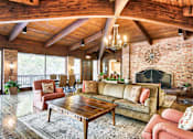 Thumbnail 17 of 24 - A living room with a fireplace and a couch at The Meadows Apartments, Culver City , CA 90230