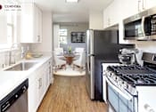 Thumbnail 21 of 39 - A kitchen with white cabinets and a black fridge at Mission Hills, Camarillo, 93012