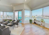 Thumbnail 2 of 34 - A dining room with a table set for six with a view of the city at Esprit Marina del Rey, 90292