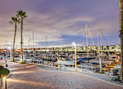 Thumbnail 33 of 34 - A marina at dusk with boats docked and palm trees at Esprit Marina del Rey, 90292