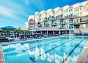 Thumbnail 34 of 34 - A large swimming pool in front of a multi-story hotel at Esprit Marina del Rey, 90292