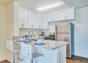 Thumbnail 6 of 13 - a kitchen with an island and stainless steel refrigerator at Villa Vicente, California