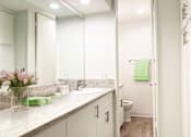 Thumbnail 13 of 23 - a bathroom with a sink and a toilet and a mirror  at Casa Granada, Los Angeles