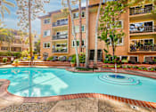 Thumbnail 14 of 23 - a swimming pool with an apartment building in the background at Casa Granada, Los Angeles, CA, 90049