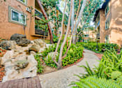 Thumbnail 23 of 23 - a walkway leading to a building with rocks and plants at Casa Granada, Los Angeles, CA