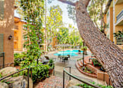 Thumbnail 15 of 23 - a courtyard with a swimming pool and a tree at Casa Granada, Los Angeles, California