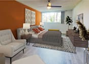 Thumbnail 7 of 23 - a bedroom with an orange accent wall and a bed at Casa Granada, Los Angeles, 90049