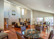 Thumbnail 10 of 17 - a living room with a glass table and a fireplace at Valley Plaza Villages, Pleasanton, California