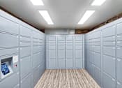 Thumbnail 18 of 24 - a bunch of white lockers in a room with a wood floor at The Meadows Apartments, Culver City , CA 90230