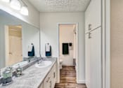 Thumbnail 9 of 14 - a bathroom with a sink and a mirror and a closet at Mediterranean Village Costa Mesa, Costa Mesa, 92626