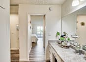 Thumbnail 11 of 14 - an open kitchen with a large mirror and a hallway to a bedroom at Mediterranean Village Costa Mesa, Costa Mesa