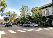 Thumbnail 11 of 12 - a city street with cars parked in front of a restaurant at Pleasanton Place, California, 94566