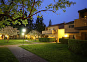 Thumbnail 17 of 17 - the apartments are lit up at night and the courtyard is empty at Valley Plaza Villages, California, 94566