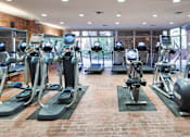 Thumbnail 19 of 24 - A gym with treadmills, exercise bikes, and other equipment at The Meadows Apartments, Culver City , CA 90230