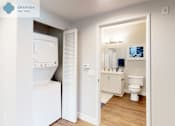 Thumbnail 27 of 39 - A white washing machine is in a small room with a toilet and a cabinet at Mission Hills, Camarillo, 93012
