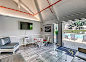Thumbnail 18 of 19 - A modern living room with a pool outside.