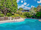 Thumbnail 4 of 16 - A swimming pool surrounded by a wooden fence and trees at Mariners Village, Marina del Rey, 90292