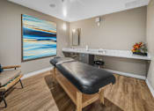 Thumbnail 27 of 34 - A room with a massage table and a painting on the wall at Esprit Marina del Rey, 90292