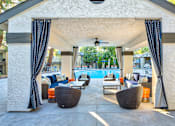 Thumbnail 13 of 16 - A patio with a pool and furniture.