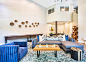 Thumbnail 1 of 16 - A living room with a blue couch and a wooden coffee table.