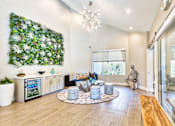 Thumbnail 15 of 16 - A living room with a green wall and a wooden bench.
