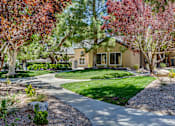 Thumbnail 4 of 16 - A house with a garden in front of it.