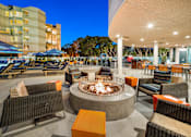 Thumbnail 17 of 34 - A fire pit sits in the middle of a patio with chairs around it at Esprit Marina del Rey, 90292