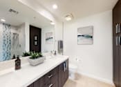 Thumbnail 14 of 34 - A bathroom with a white counter top and a toilet in the corner at Esprit Marina del Rey, 90292