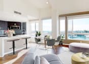 Thumbnail 10 of 34 - A modern living room with a bar area and a view of the water at Esprit Marina del Rey, 90292