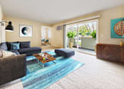 Thumbnail 2 of 12 - A living room with a blue rug and a grey couch at Pleasanton Place, Pleasanton, CA, 94566