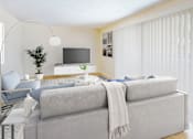 Thumbnail 6 of 12 - A modern living room with a grey sofa and a television.