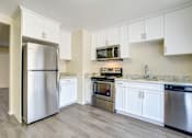Thumbnail 8 of 13 - A kitchen with a refrigerator, oven, and microwave at Pleasanton Heights, California
