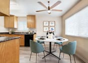 Thumbnail 3 of 12 - A kitchen with a table set for two and a ceiling fan at Pleasanton Place, Pleasanton, CA, 94566