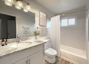 Thumbnail 10 of 13 - A white bathroom with a toilet, sink, and shower at Pleasanton Heights, California