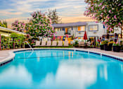 Thumbnail 1 of 12 - A swimming pool surrounded by a fence and trees at Pleasanton Place, Pleasanton, CA, 94566