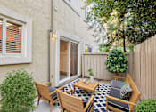 Thumbnail 7 of 12 - A patio with a table and chairs at Pleasanton Place, Pleasanton, CA, 94566