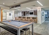 Thumbnail 30 of 34 - A pool table is in the middle of a room with a bar and a television at Esprit Marina del Rey, 90292