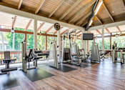Thumbnail 8 of 13 - A gym with a variety of equipment including treadmills, weights, and a television at Rancho Los Feliz, Los Angeles, California