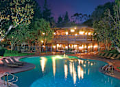 Thumbnail 3 of 24 - A large swimming pool in front of a lit building at night at The Meadows Apartments, Culver City , CA 90230