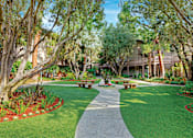 Thumbnail 22 of 24 - A walkway in a park with benches on either side at The Meadows Apartments, Culver City , CA 90230