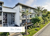 Thumbnail 9 of 24 - The Tides is a modern apartment complex with white buildings and palm trees at Marina Harbor, California, 90292