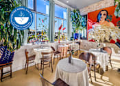 Thumbnail 7 of 34 - A restaurant with tables and chairs and a United Nations sign at Esprit Marina del Rey, 90292