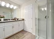 Thumbnail 7 of 17 - A bathroom with a white door and a glass shower at Valley Plaza Villages, California, 94566