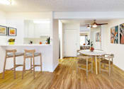 Thumbnail 6 of 16 - A dining room with a table and chairs at Village Pointe Apartments, Northridge, California