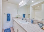 Thumbnail 8 of 13 - A bathroom with a sink, mirror, and towel rack at Villa Vicente, Los Angeles, CA