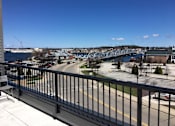 Thumbnail 15 of 19 - A view from a balcony overlooking a bridge and a river.