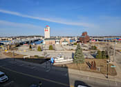 Thumbnail 16 of 19 - A view of a parking lot with a white car and a white van.